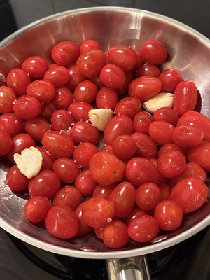 Italian homemade tomato sauce step 2: cherry tomatoes slowly cooking